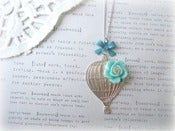 Image of Silver Hot Air Balloon Necklace with Blue Flower
