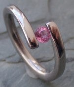 Image of Twist of Fate Titanium Tension Set Ring Pink Sapphire Super Shiny Finish Band