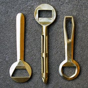 Image of cast brass bottle openers