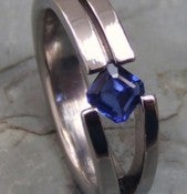 Image of Graceful Titanium Tension Set Split Band 1/2 Carat Princess Cut Blue Sapphire