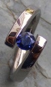 Image of Titanium Tension Set Twist of Fate Band 1/2 Carat Round Blue Sapphire Ring