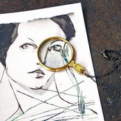 Image of brass magnifying lens necklace
