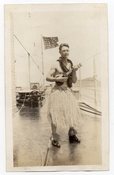Image of SAILOR IN HULA SKIRT PLAYS UKELELE GAY INT 