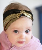 Image of tiny metallic gold and black turban