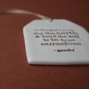 Image of ceramic quote tag - to forget how to dig the earth