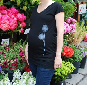 Image of dandelion on black banded maternity tunic