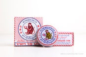 Image of White Monkey Holding Peach Balm