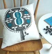 Image of pomegranate tree cushion in teal on white linen