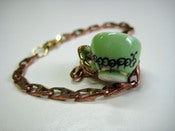 Image of Caterpillar tea cup charm bracelet