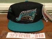 Image of VINTAGE JACKSONVILLE JAGUARS ALL OVER TEXT SPORTS SPECIALTIES SNAPBACK CAP HAT