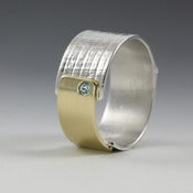 Image of sterling silver and 18k gold papyrus ring with blue zircon stone