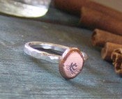 Image of silver and copper pebble hand stamped initial stacking ring