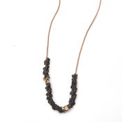 Image of thirteen oxidized silver & two 14k vertebrae on wax-coated cotton (P20B10sil14k28)