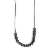 Image of fifteen oxidized silver vertebrae on 28" wax coated cotton (P20B10sil28)