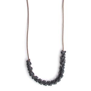 Image of fifteen oxidized silver vertebrae on 28" wax coated cotton (P20B10sil28)