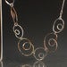 Image of asymmetrical link like a pretzel necklace