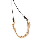 Image of brass fish jaw on black wax coated cotton w/ brass button closure (P30bra20)