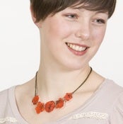 Image of Red Roses Necklace (on cream acrylic with antique gold chain)