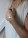 Image of gold disc bracelet with diamond 