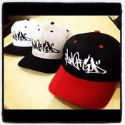 Image of scribbly tag snap backs.