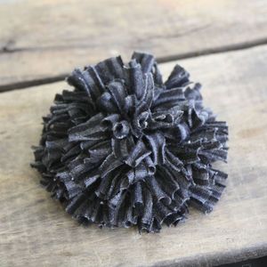 Image of ruffled mum pin - black and charcoal grey stripes