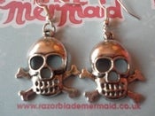 Image of Wide Eyed Skull and Crossbone Silvertone Earrings 