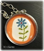 Image of Round Orange and Blue Flower Charm