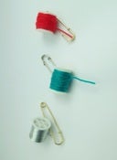 Image of woven thread brooches