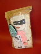 Image of lucy the doll with brooch and comic zine 