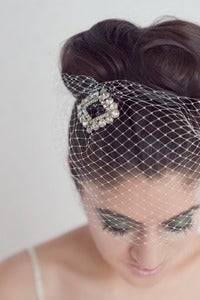 Image of Rhinestone vintage brooch atop birdcage veil