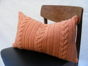 Image of Hand Knit Cushion 50 x 30cm - tangerine knotted cable