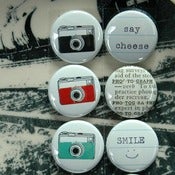 Image of say cheese badge buttons