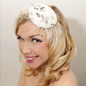 Image of Bridal veiled fascinator, decorated with wedding themed charms.