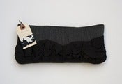 Image of a roundy-bottomed tough ruffles zipper purse in darkest grey + black
