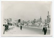 Image of MAN in SUIT WALKS DOWN WWII GERMANY BOMBED OUT STREET