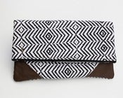 Image of a foldover clutch in black + white zigzag print