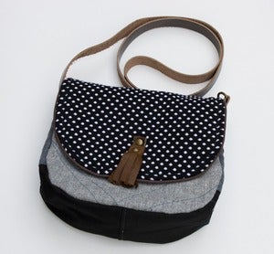 Image of -- S OL D O U T -- a small cross body bag with a black + white polka dot flap