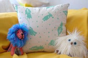 Image of astrobots pillow with piping