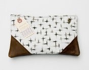 Image of large charcoal + cream brushstroke crosses print clutch with leather corners