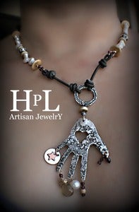 Image of Milagro Hand Pendant  fine silver artisan made garnets and fresh water pearls leather.