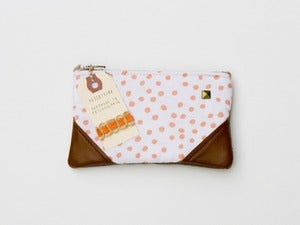 Image of -- SOLD OUT-- a small coral + white dots zipper pouch with leather corners and a METAL zipper