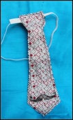 Image of reversible mustache/monkey tie