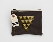 Image of a large zipper pouch in dark grey with oversized pyramid studs + a metal zipper