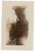 Image of MAN IN UNIFORM LIGHTS A CIGARETTE VINTAGE SNAPSHOT PHOTO 