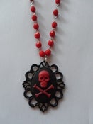 Image of Black Skull and Red Crossbone Cameo Necklace on Red Rosary Shaped Bead Chain 