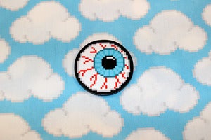 Image of 1.5" blue or purple eyeball pin