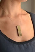 Image of 'naname' brass pendant
