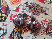 Image of Plastic Dark Antique Silver Coloured Heart Padlock Shaped Kitsch Retro Keyhole Earrings 