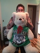 Image of Ryan's enormous childhood bear friend in a four year strong jersey