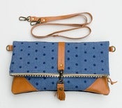 Image of foldover bag in hand stamped dots on denim